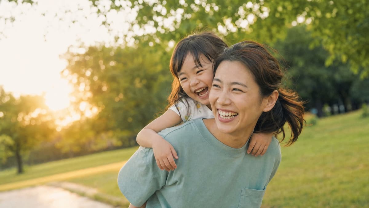 Parent and child laughing together outdoors