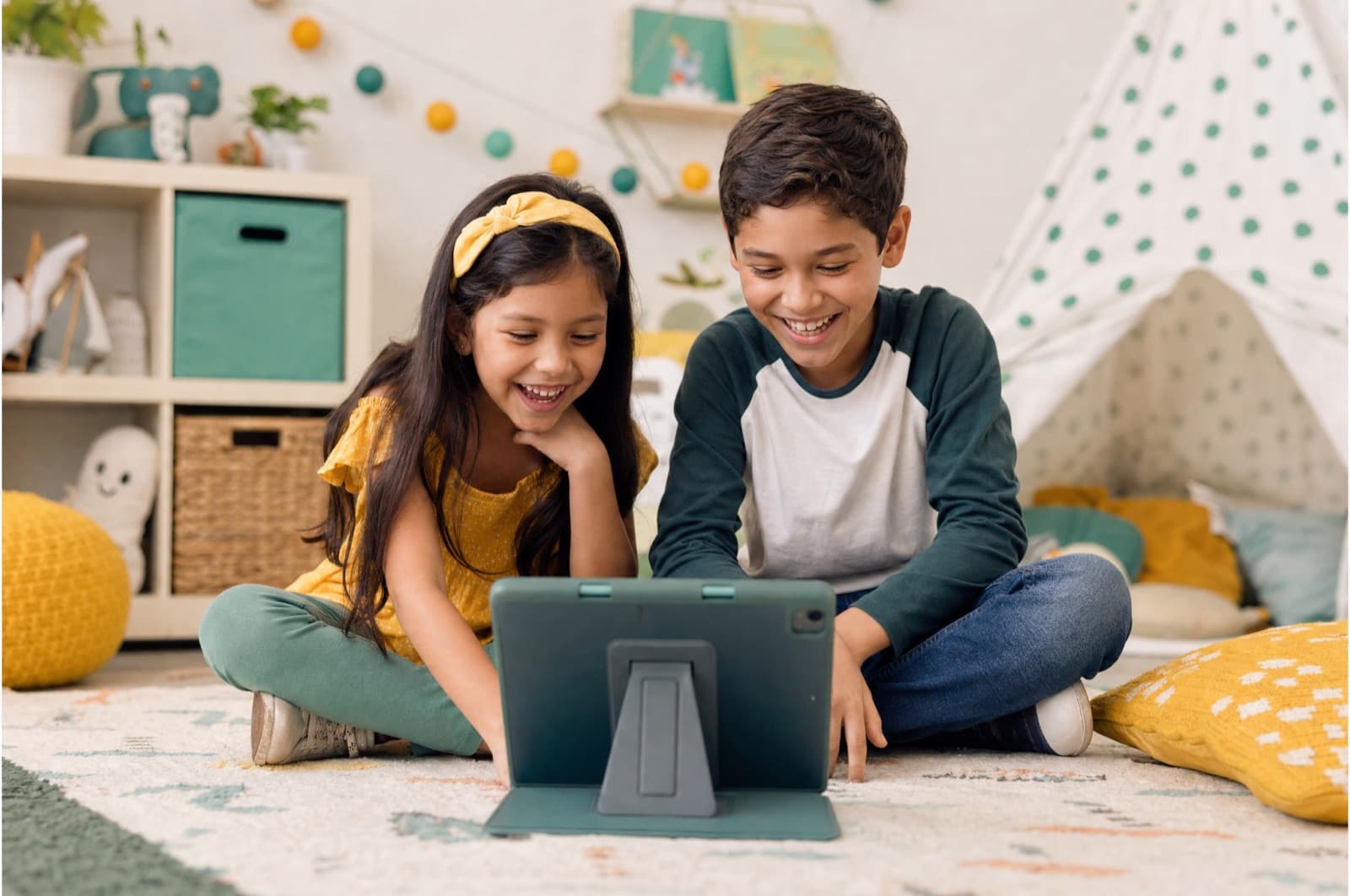 Two siblings laughing while playing a game together in KidSpace
